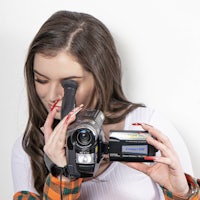 a woman holding a video camera